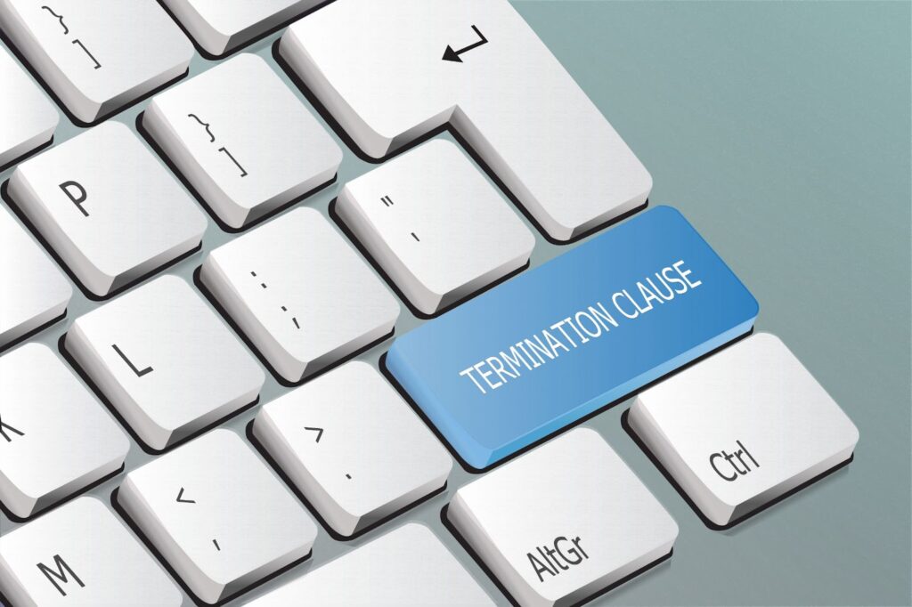 Image of computer keyboard buttons. One button is blue with text that reads "Termination Clause". Topic: hiring digital freelancers
