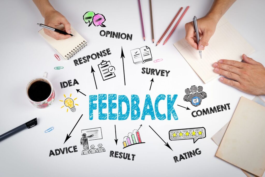 Image of the word "feedback" written in blue in the center, surrounded by words pointed at my arrows. Words such as "idea, response, opinion, survey, comment, rating, result, advice". Surrounding the words are notepads, pencils, cup of coffee, and 3 visible hands. Topic:  non-disparagement clause