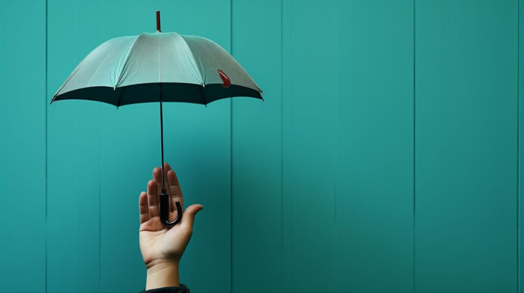 Image of right hand only visible, palm of hand is securing a small umbrella that is upright and opened. Umbrella is a mint green color as well as the background of the image is mint green. Topic: protect online course content